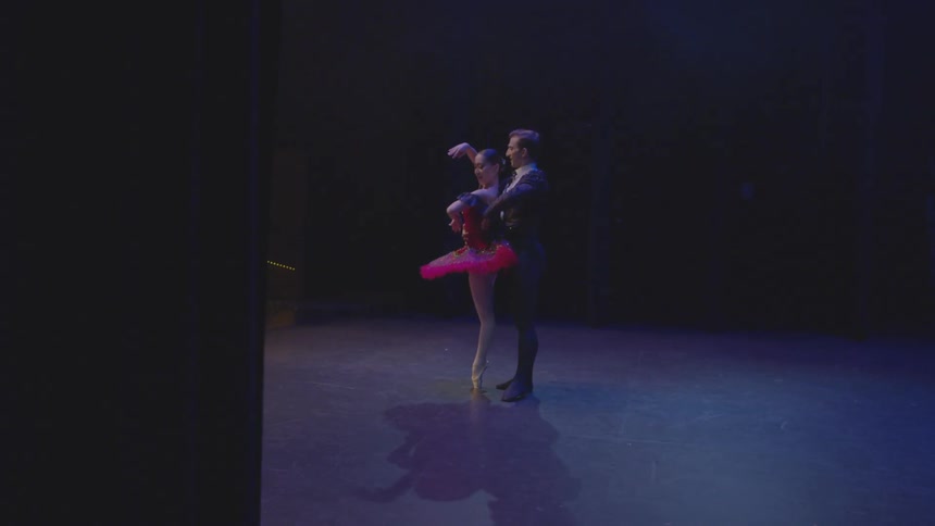 Man and woman dance together on stage