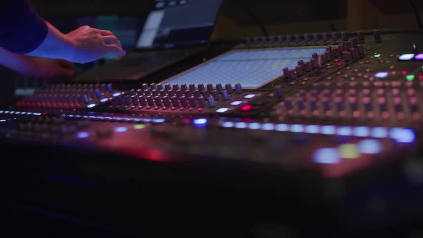 A person is operating the sound board