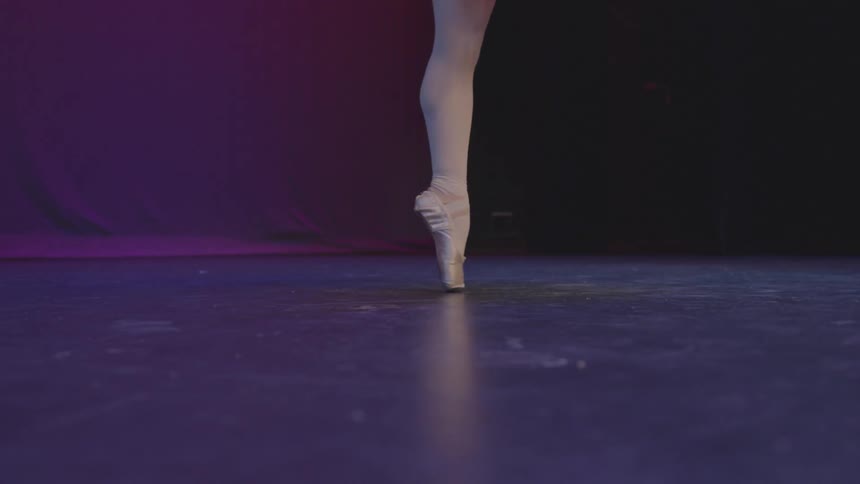 A ballerina dances on a stage