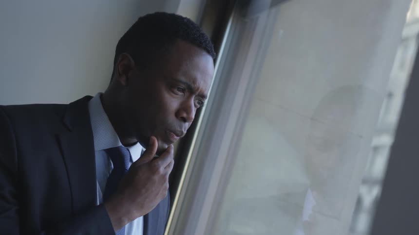 A businessman looks out a window