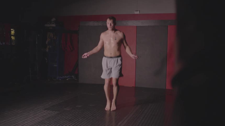 Man jumps rope in an empty room