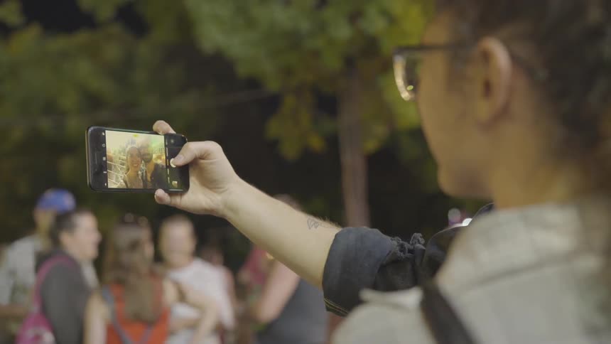 A man uses his phone to film him and his girlfriend