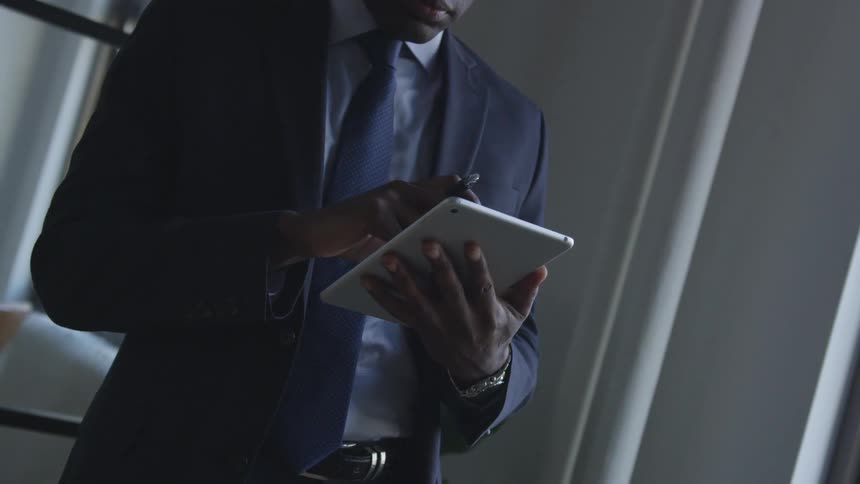 A man is touching his tablet