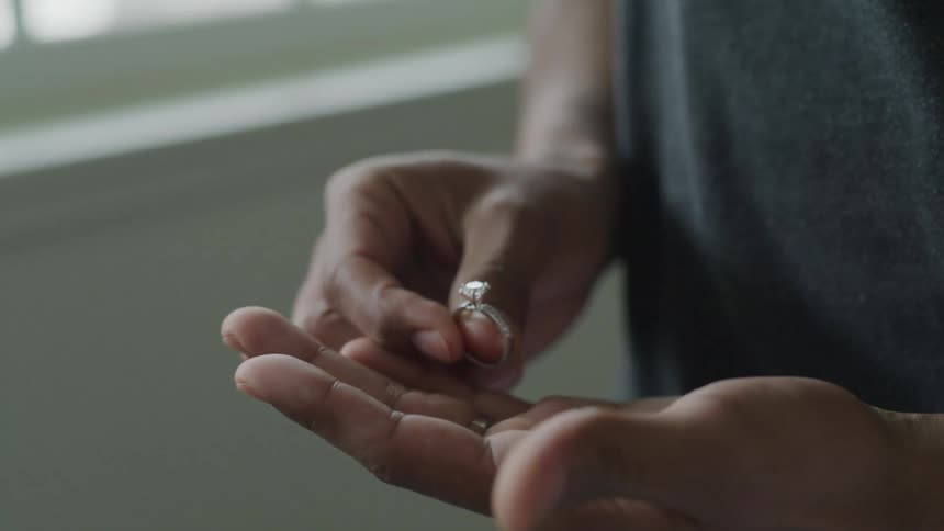 Man is holding a wedding ring