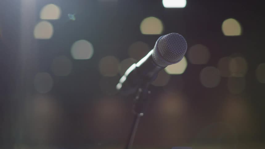 The microphone sits still on the stage