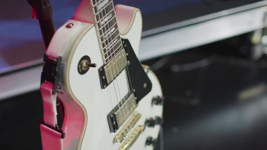 A guitar sits on a stage