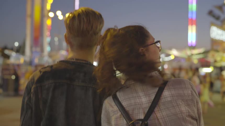 A couple walk into a carnival