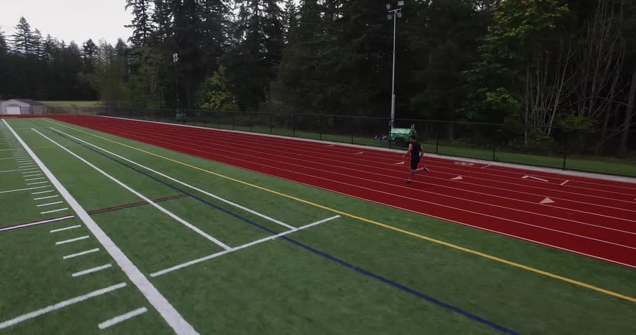 The person is running very fast on the track