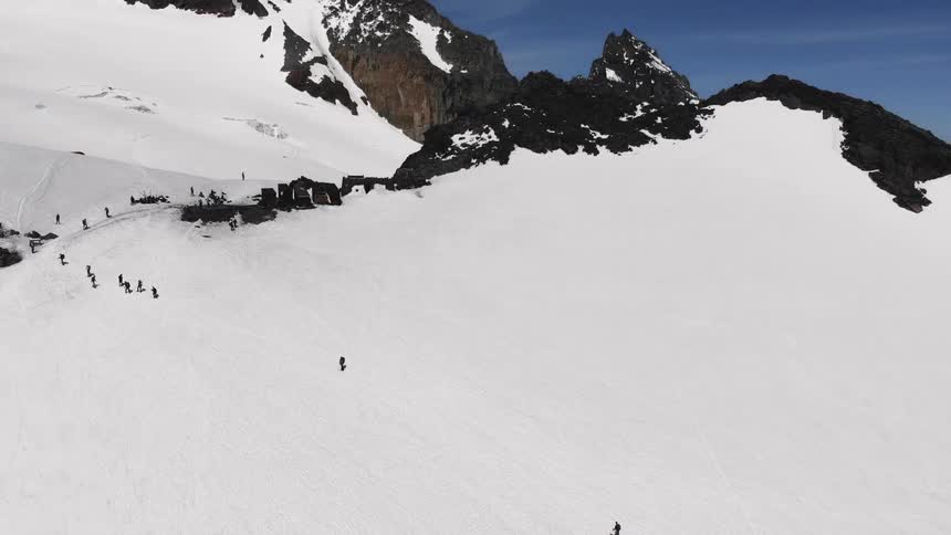 A line of people on a snow covered mountain