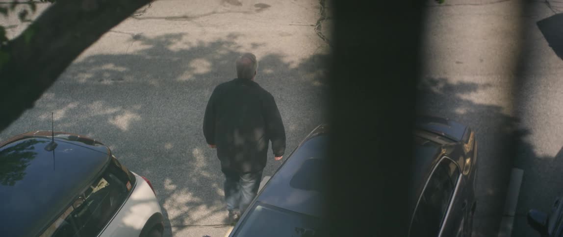 A man walks down the street below