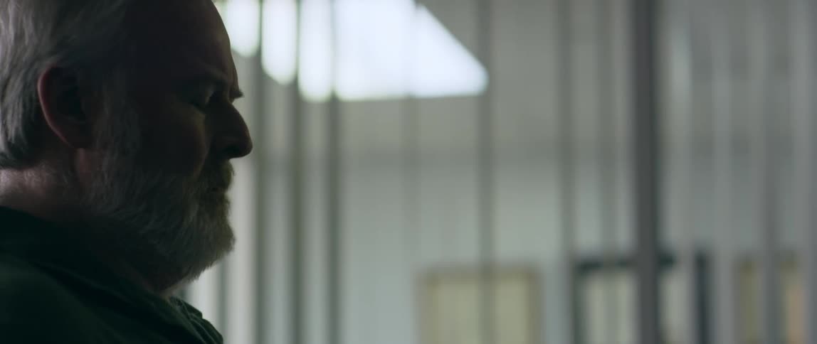 A man shakes his head while sitting in an office