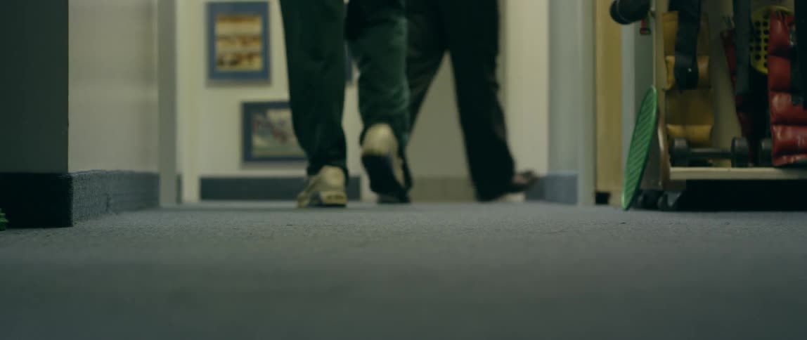 The two people walk down the hall