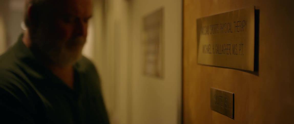 A man is entering the office of a physical therapist