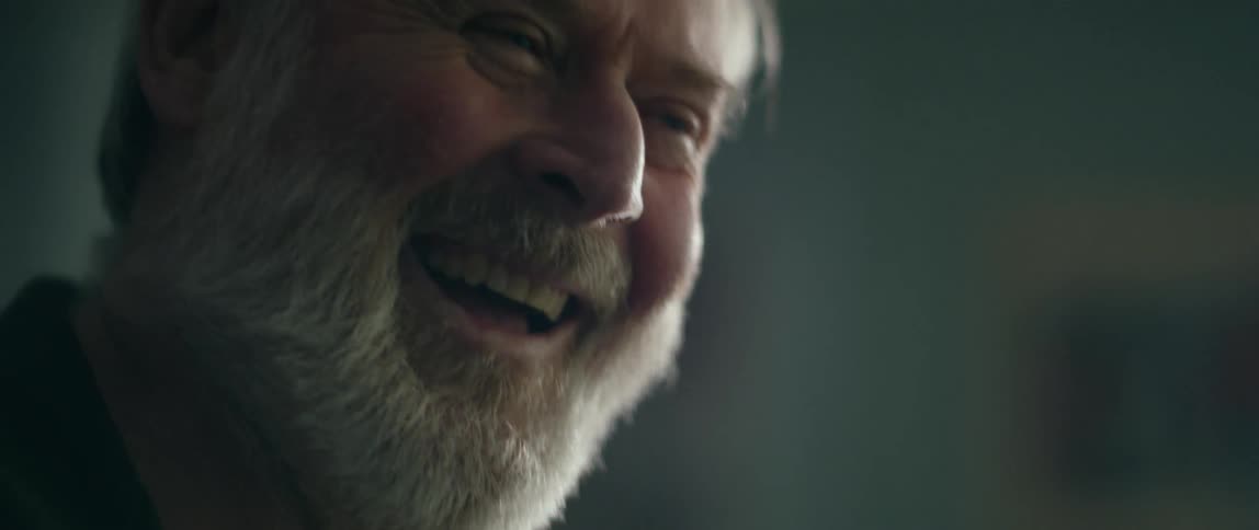 A man laughs and talks