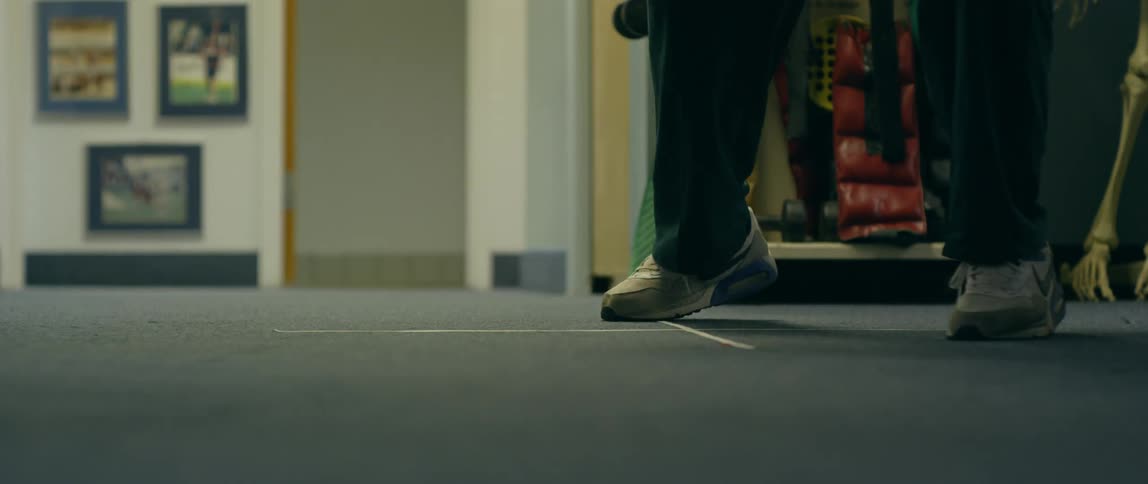 Young child jumps back and forth over the lines on the floor