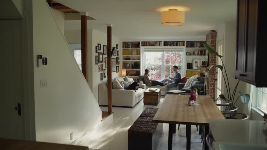 Man Sits Down in Window Seat with Woman