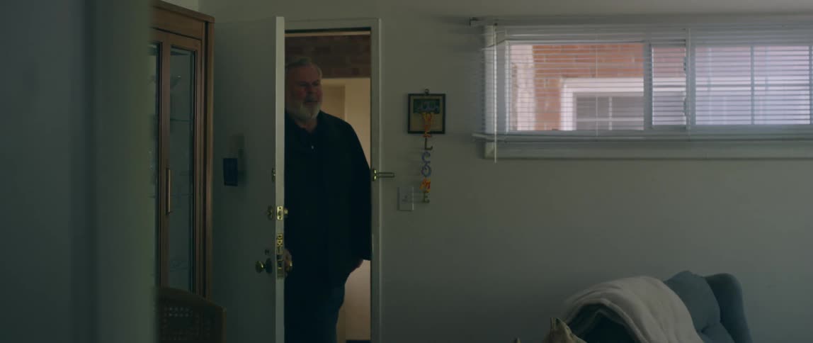 A man enters the room and closes the door