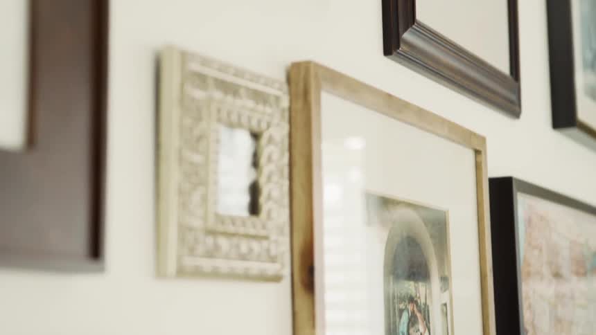 Framed photographs hang on a wall