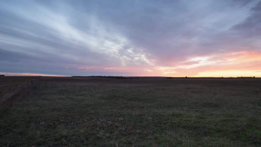 Clouds move over the large field