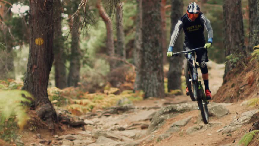 A mountain biker jumping over a rock