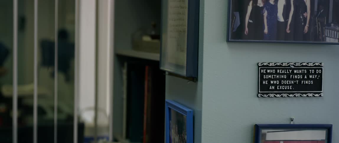 The walls are covered with portraits and plaques