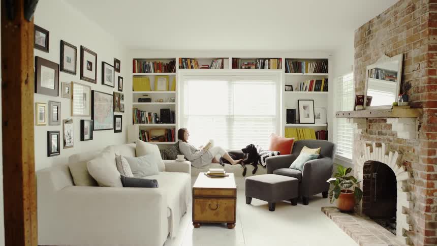 Woman and Dog Share a Window Seat in a Cute Living Room