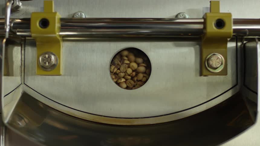 Coffee beans spin inside machinery