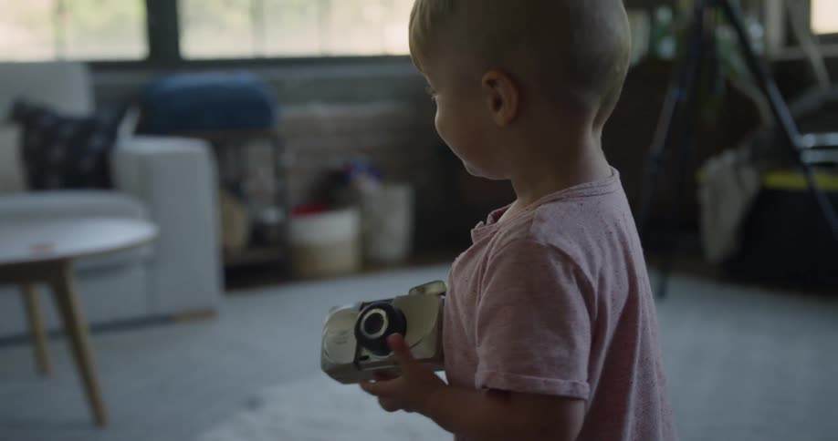 A boy holds a camera