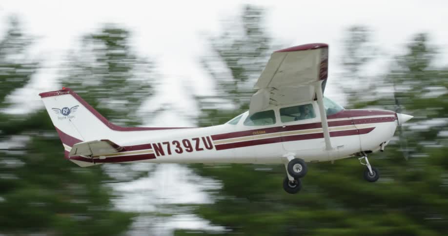 A small airplane takes off from a runway