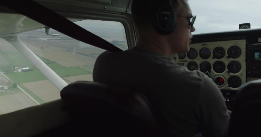 Pilot Flying Cessna Plane Above City
