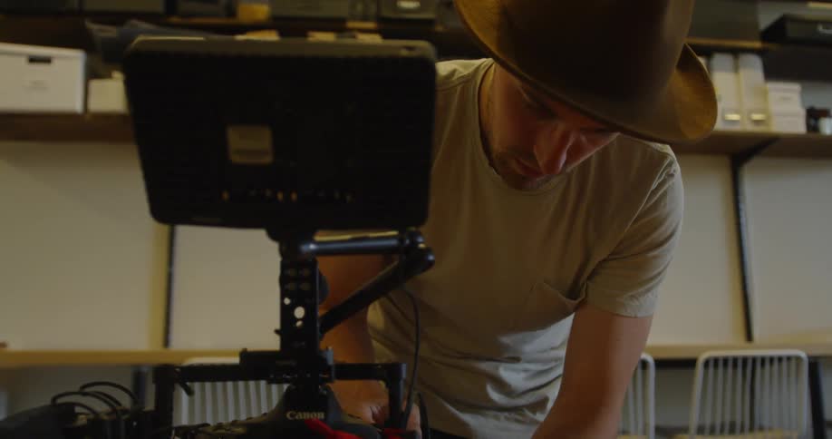 A man sets up camera equipment