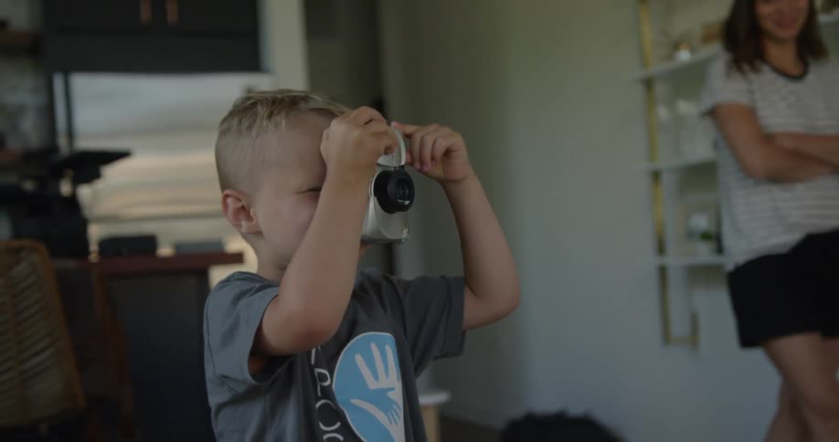 Child looks through a camera