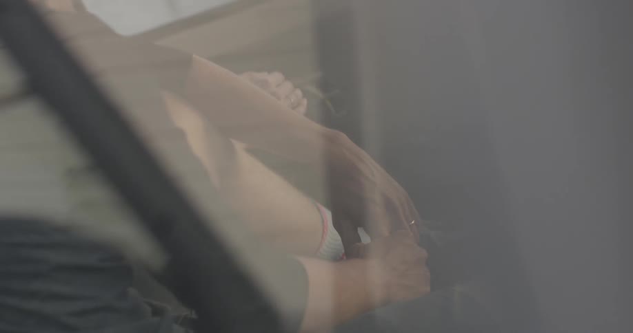 A man and woman sit in a parked truck