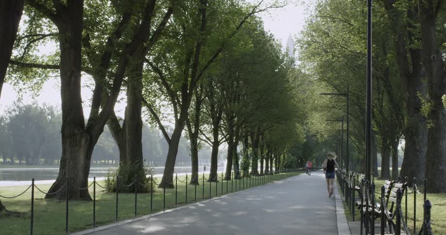 A woman jogs on a path at the National Mall in Washington DC