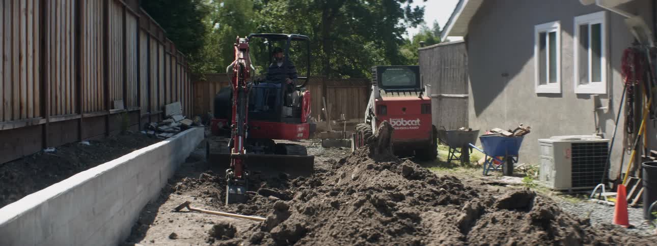 An excavator digs up dirt at a construction site