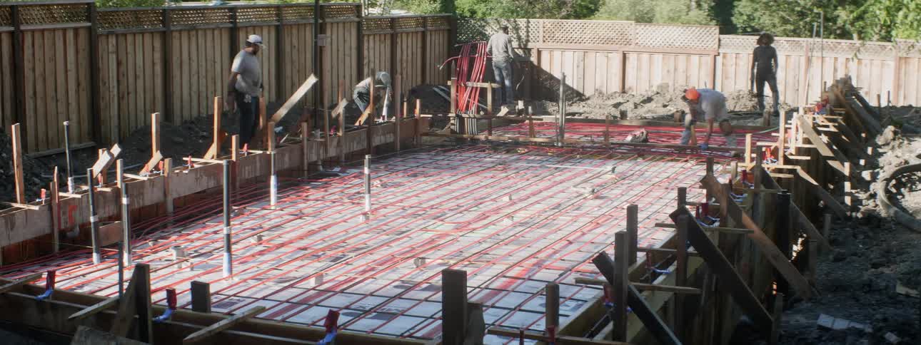 Construction workers work on a building foundation