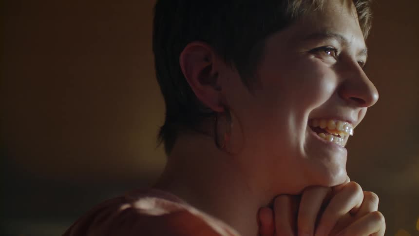 A woman smiles while talking