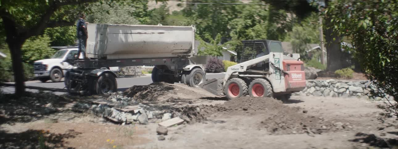 Heavy equipment digs up dirt at a construction site