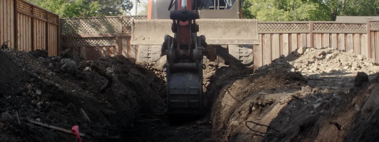 An excavator digs up dirt at a construction site