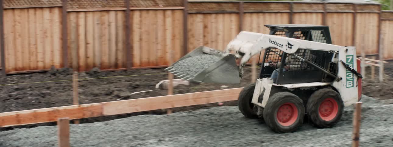 Men work on the foundation of a building