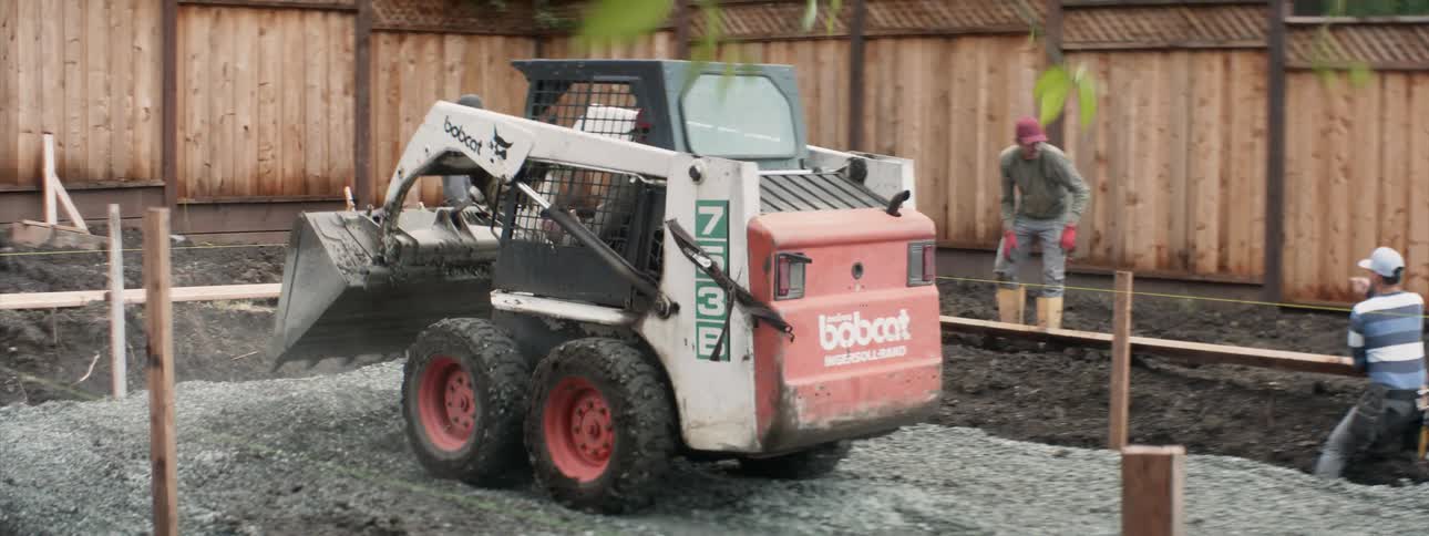 The bulldozer is flattening the cement