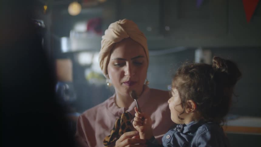The woman is being fed by the child