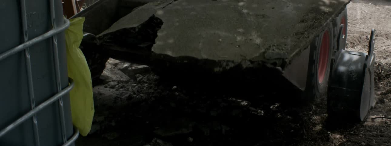 Heavy machinery tears out concrete at a construction site