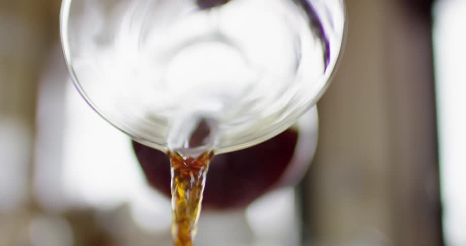 A drink being poured from a clear container