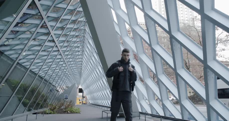 A man poses in a city