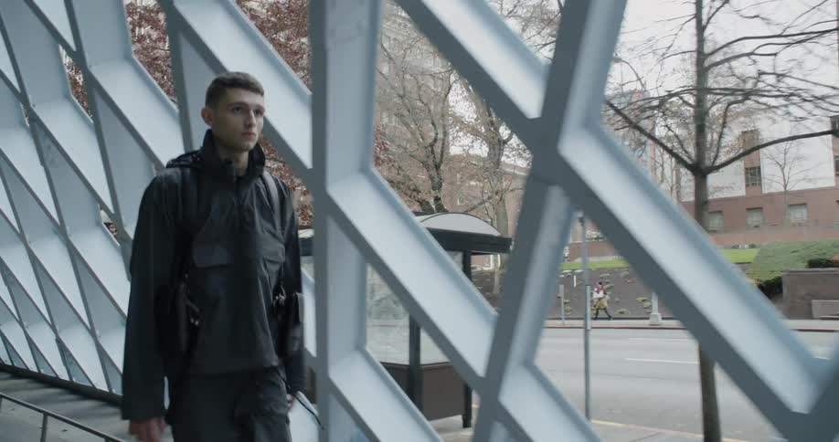 Man walks in a tunnel next to the road
