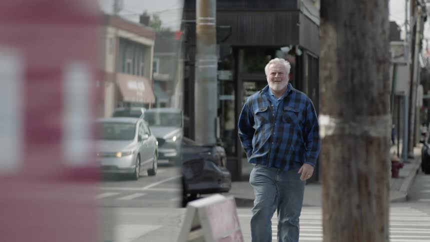 A man crosses a city street