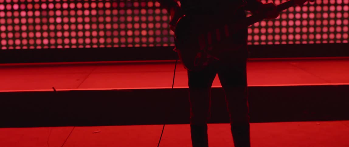 A man plays guitar on a stage
