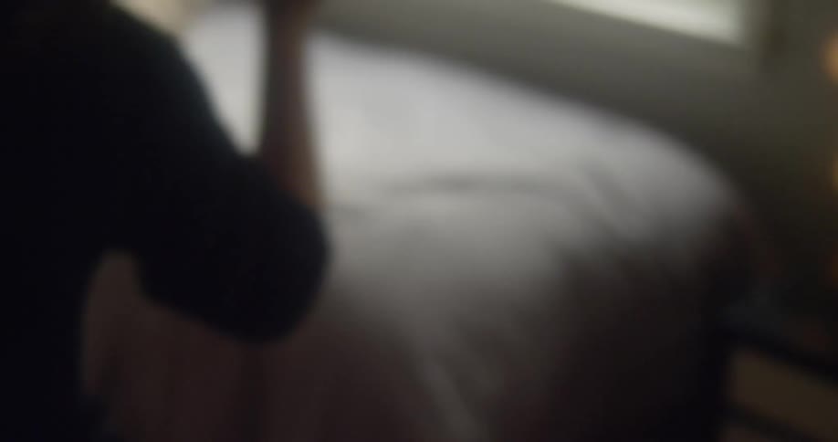 A woman dances in a bedroom