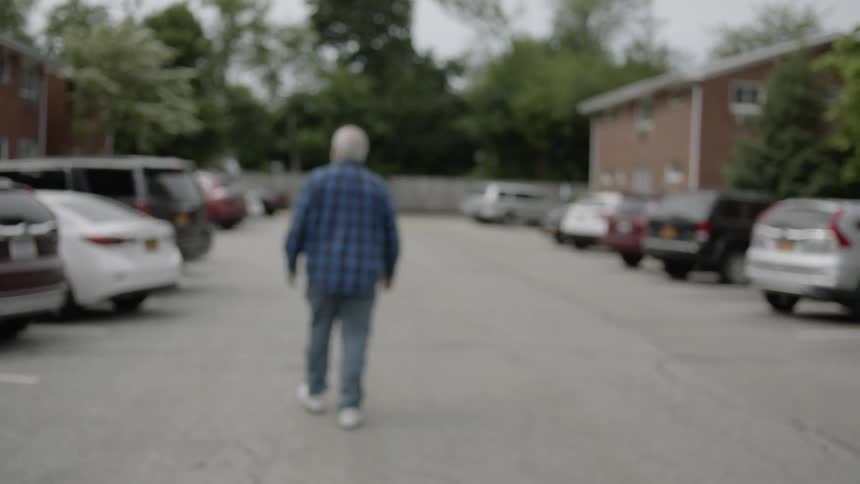 Man walks through a parking lot